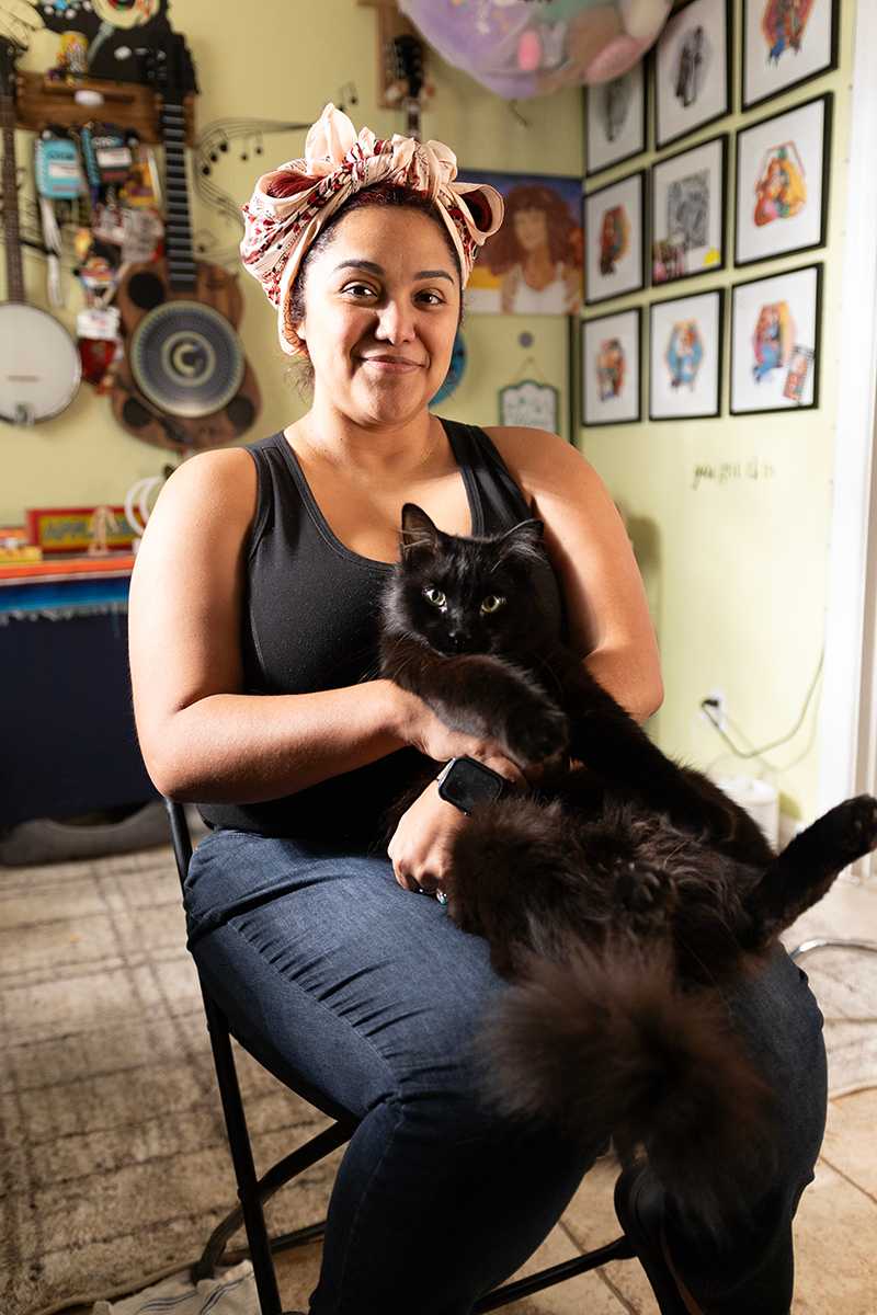 Veronique sitting on a chair with her cat